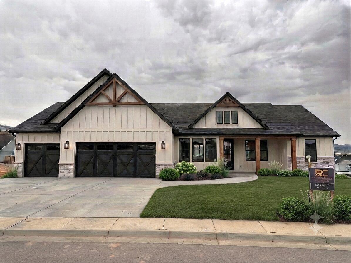 Iron Crest Phase 2B home exterior — white board-and-batten siding with stone accents and a three-car garage